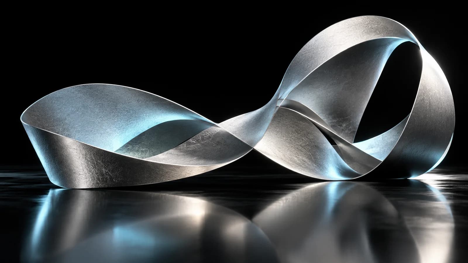 A folded silver ribbon forming a continuous sculpture, representing an idea developing into finished content